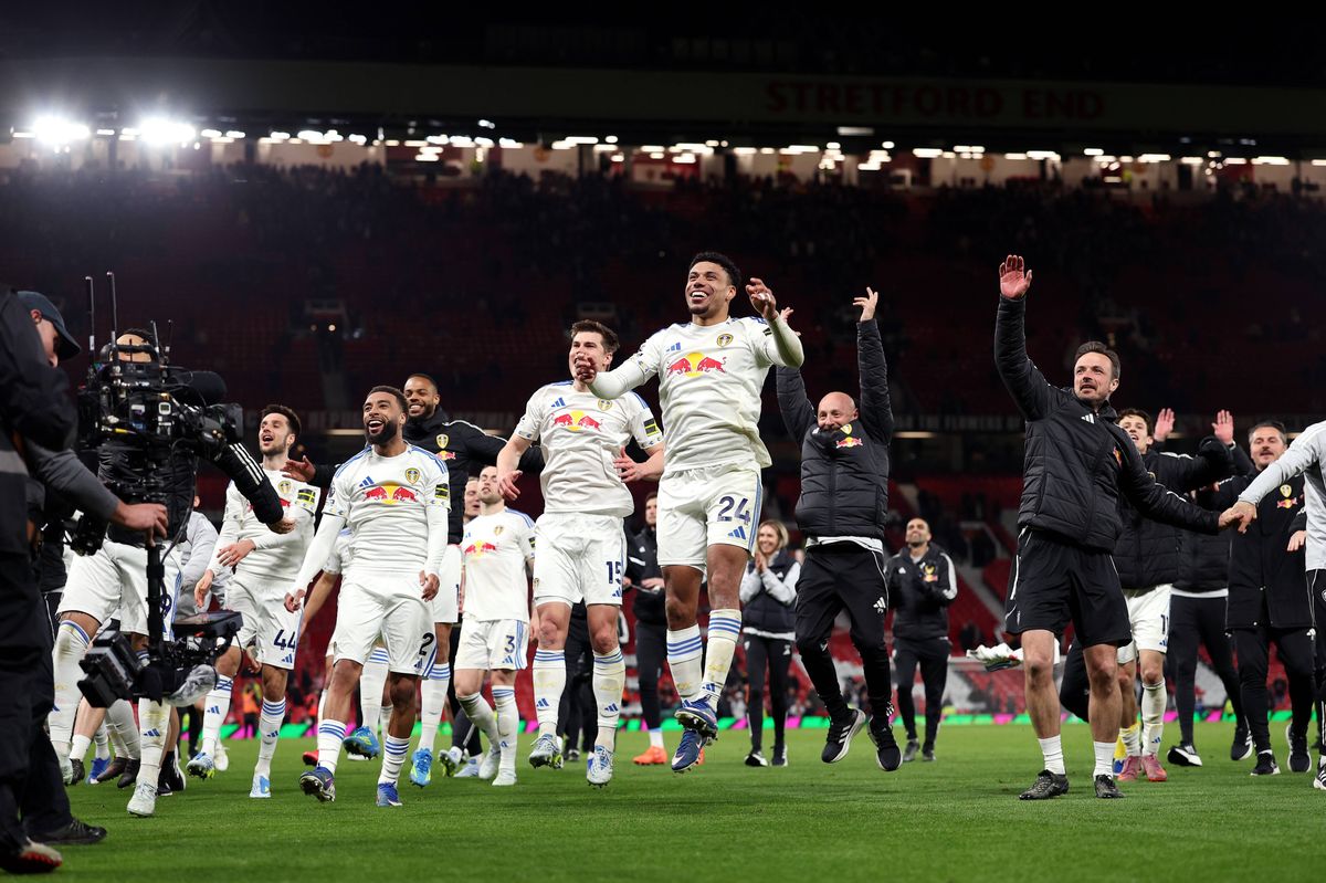Players of Leeds United celebrate towards their fans after the team's victory in the Premier League match between Manchester United and Leeds United. 