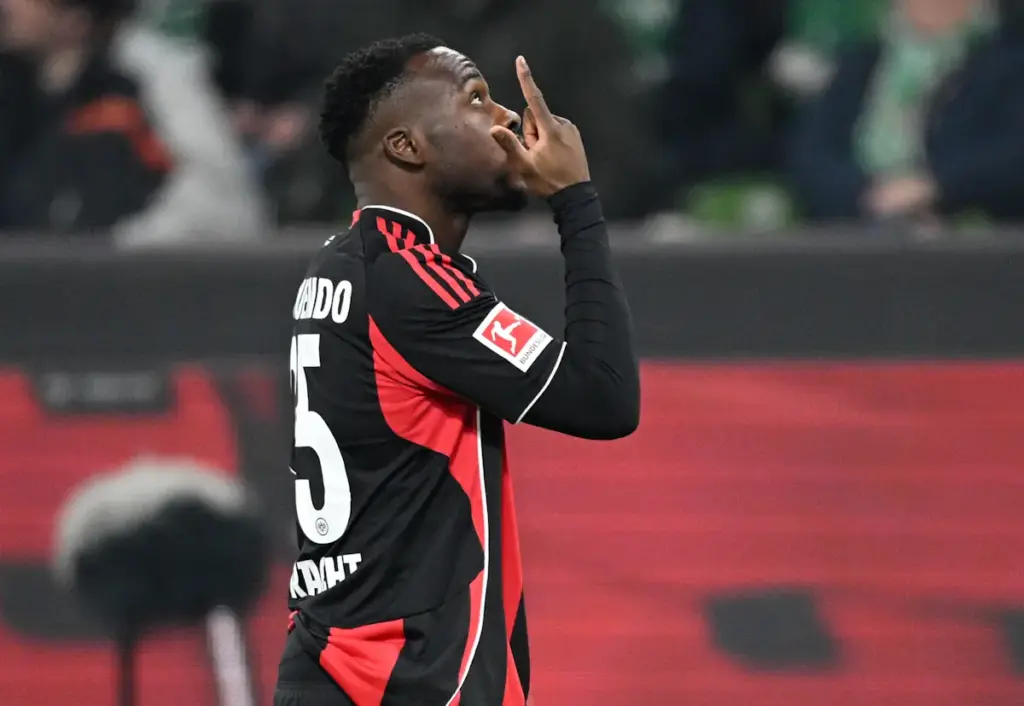 Arnaud Kalimuendo points towards the sky after scoring for Eintracht Frankfurt