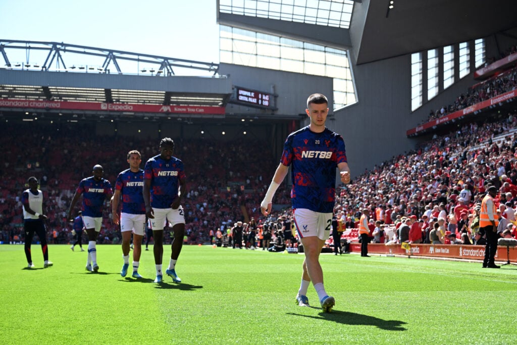 Crystal Palace players, led by Adam Wharton, warm up ahead of their Premier League match against Liverpool at Anfield