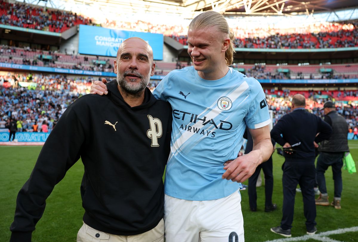 Pep Guardiola celebrates a win at Wembley with Erling Haaland