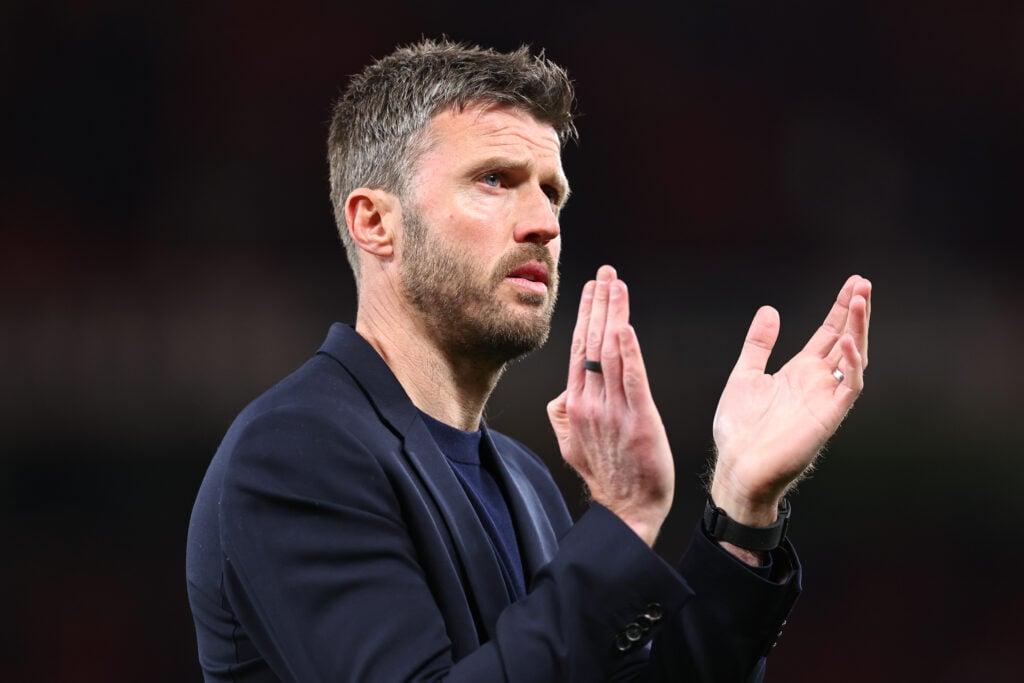 Michael Carrick applauds the fans at full-time during the Premier League match between Manchester United and Brentford at Old Trafford in 2026 in Manchester, England.