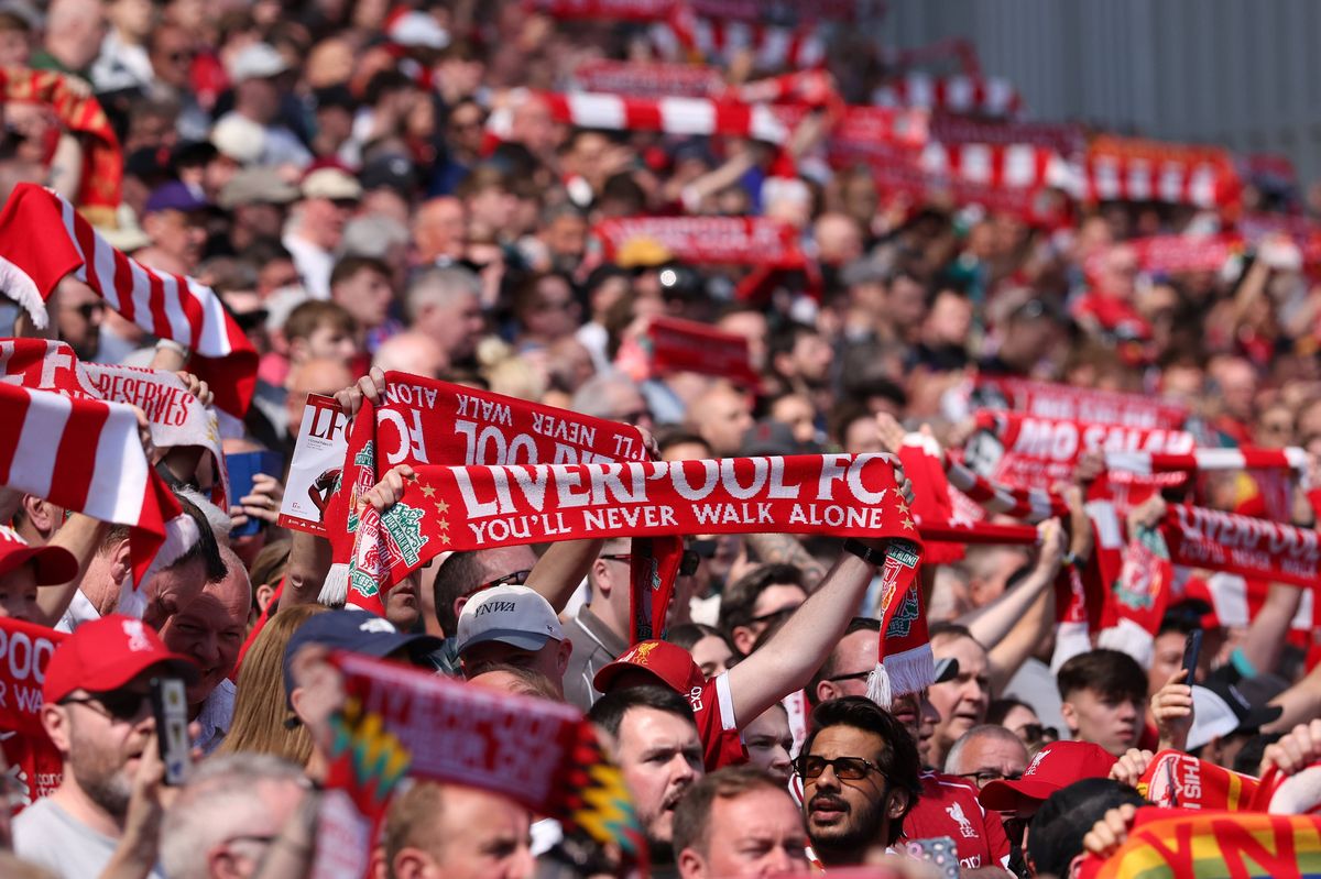 Fans of Liverpool hold their scarves a loft prior to the Premier League match between Liverpool and Crystal Palace