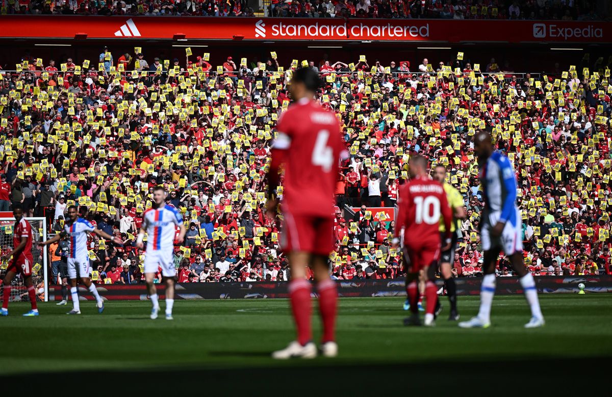Liverpool fans hold up posters protest against rising ticket prices and the owner, John Henry with posters that read 'Caution, Anfield's soul at risk' during the Premier League match between Liverpool and Crystal Palace at Anfield