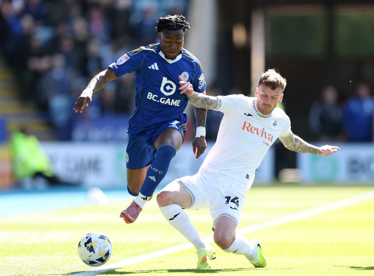 Abdul Fatawu of Leicester City is tackled by Josh Tymon of Swansea City 
