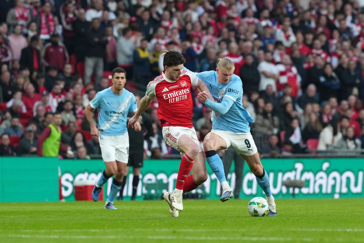 Declan Rice of Arsenal and Erling Haaland of Manchester City battle for the ball during the Carabao Cup Final