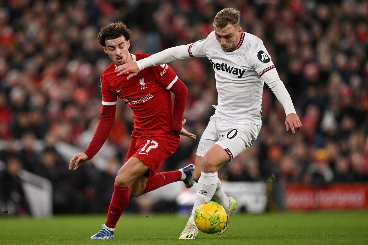 Liverpool's English midfielder #17 Curtis Jones (L) fights for the ball with West Ham United's English striker #20 Jarrod Bowen during the English League Cup quarter-final football match between Liverpool and West Ham United at Anfield in Liverpool, north west England on December 20, 2023. 