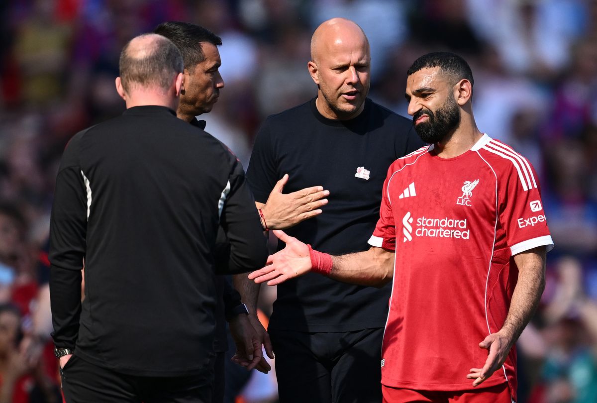 Mohamed Salah of Liverpool reacts with Arne Slot, Manager of Liverpool, after being substituted off during the Premier League match between Liverpool and Crystal Palace at Anfield on April 25, 2026 in Liverpool, England