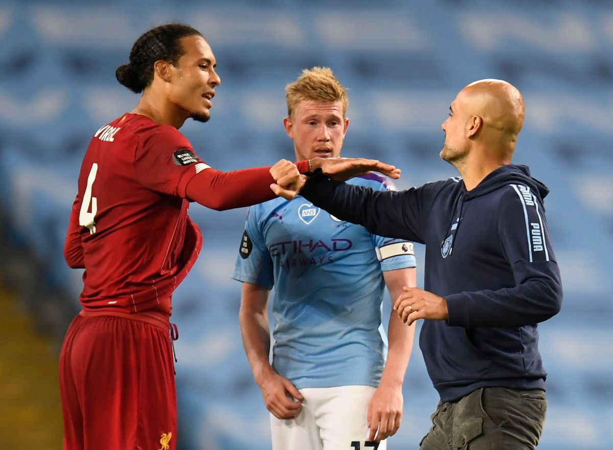  Virgil van Dijk of Liverpool interacts with Kevin De Bruyne and Pep Guardiola