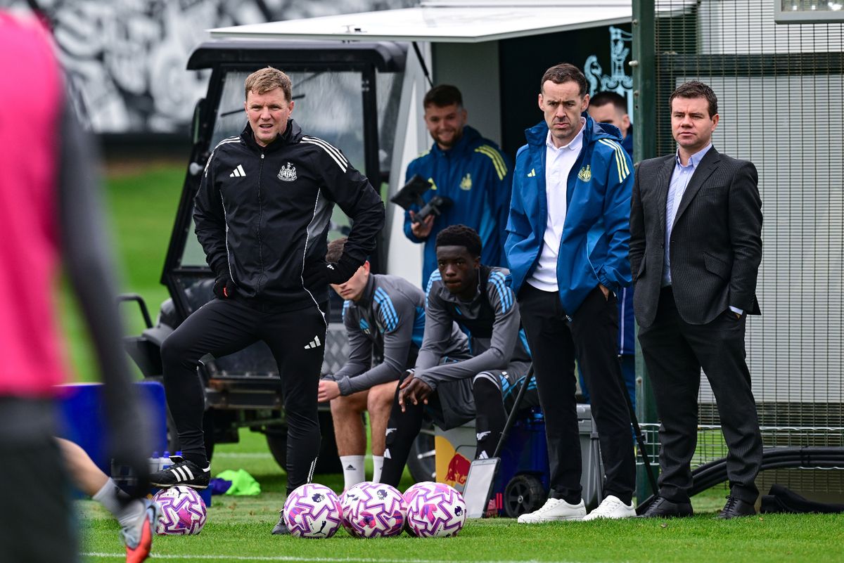 Newcastle United sporting director Ross Wilson (R) watches training with performance director James Bunce (C) and head coach Eddie Howe  (R)