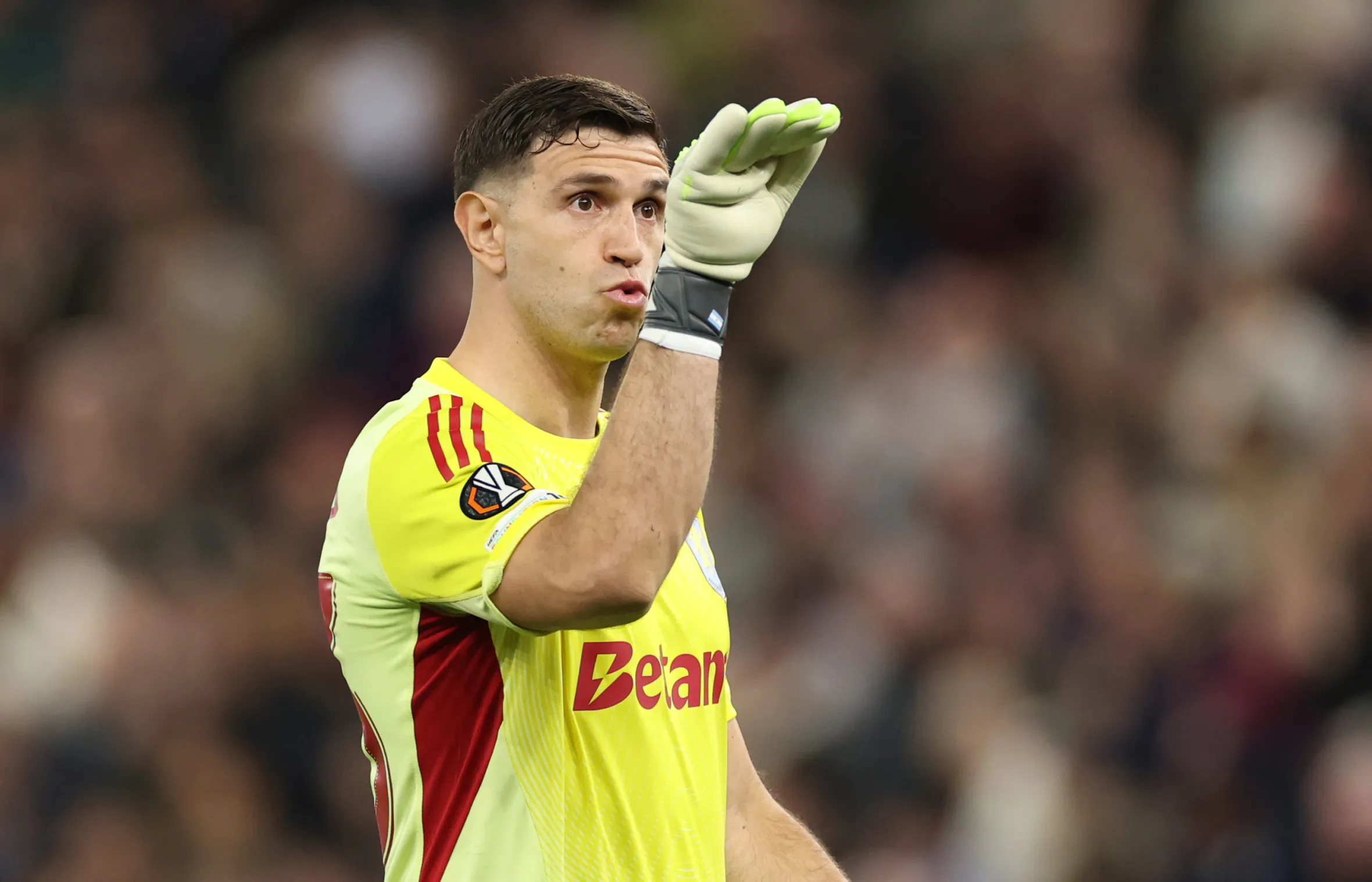 Aston Villa goalkeeper Emiliano Martinez gestures during a match.