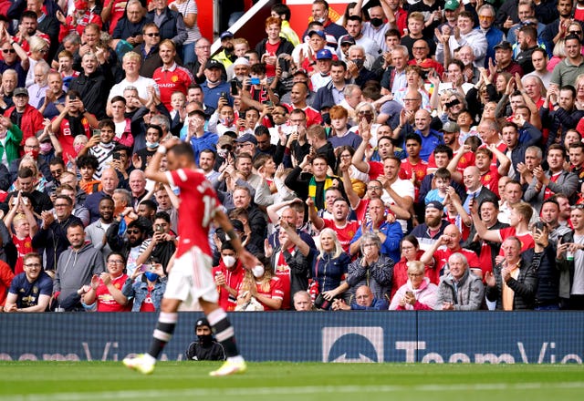 Manchester United fans celebrate a Bruno Fernandes goal against Leeds in 2021.