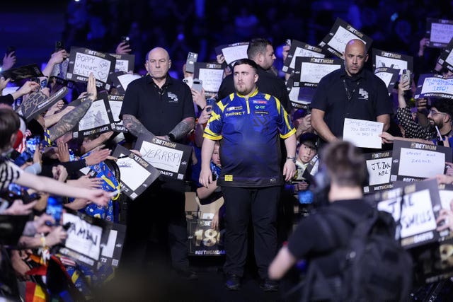 Luke Littler walks out at the AO Arena