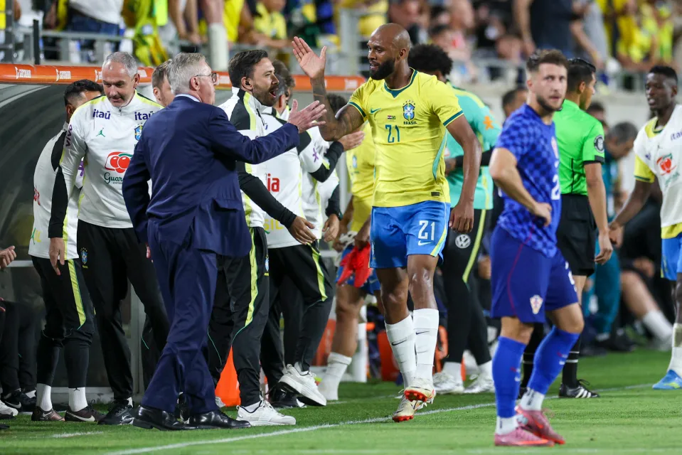 Brazil forward Igor Thiago (21) reacts with head coach Carlo Ancelotti after scoring a goal against Croatia