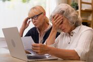 Stressed senior women looking at financial bills