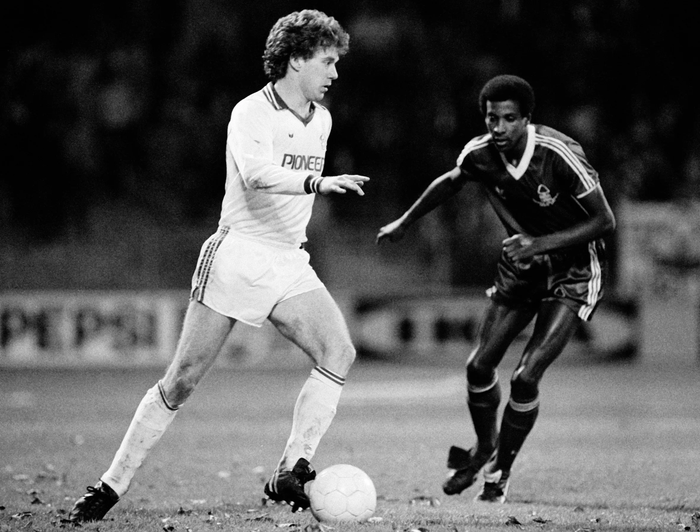 Tony Woodcock of FC Cologne with Viv Anderson of Nottingham Forest on the soccer field.