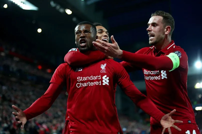 Georginio Wijnaldum celebrates with Jordan Henderson and Trent Alexander-Arnold