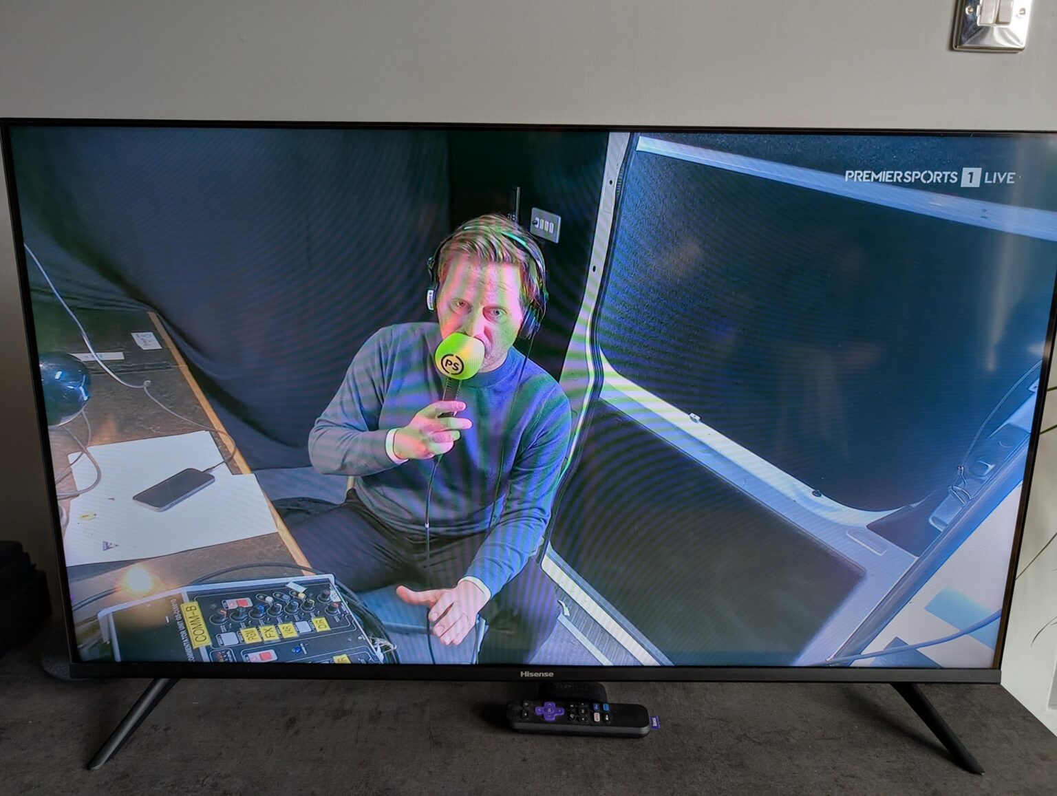 Man is doing comms from a remote secure location. The cupboard under his stairs.