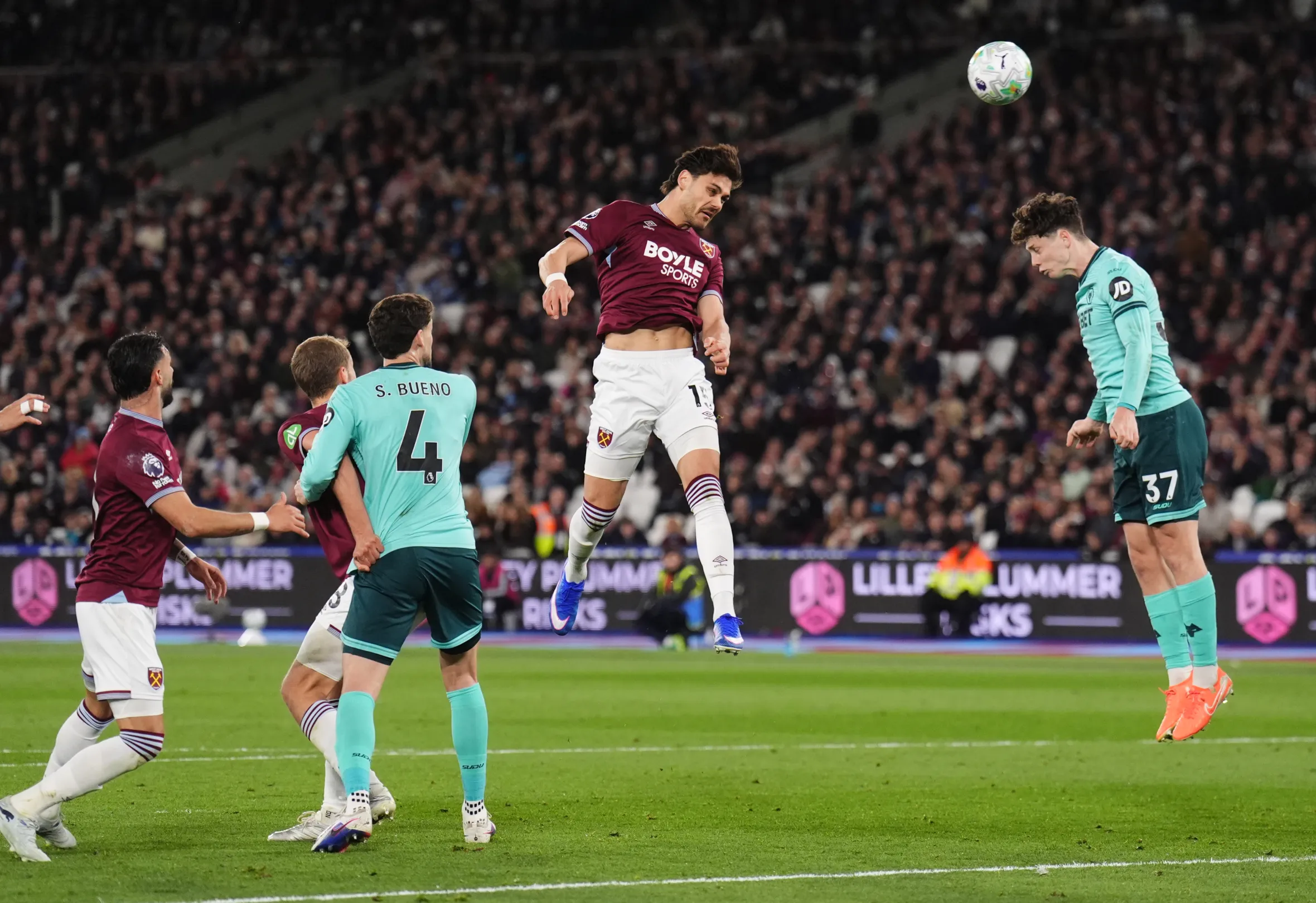Konstantinos Mavropanos scoring West Ham United's first goal with a header during a football match.