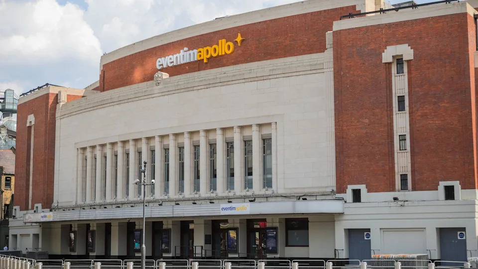 A photo of the outside of a music venue, an early 20th century building with Art Deco design. 
