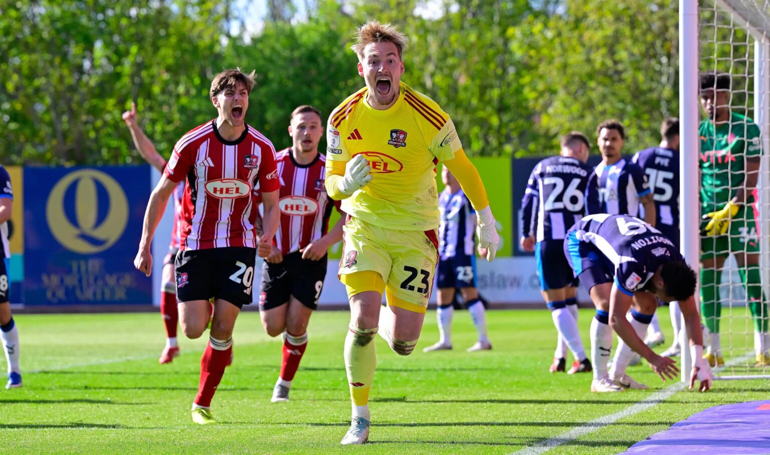 Exeter City goalkeeper Jack Bycroft celebrates scoring a late equalizer.