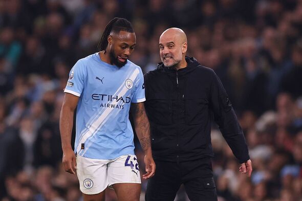 Pep Guardiola, Manager of Manchester City, interacts with Antoine Semenyo of Manchester City during the Premier League match bet