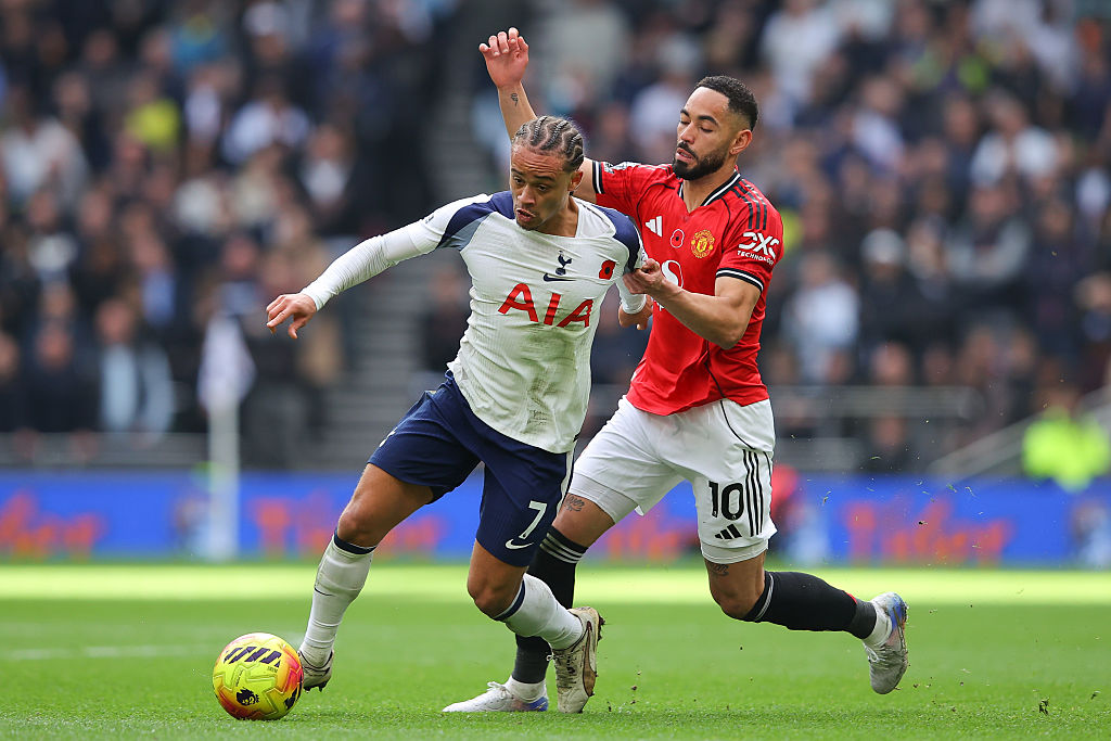 Xavi Simons of Tottenham Hotspur battles for possession with Matheus Cunha of Manchester United during the Premier League match between Tottenham Hotspur and Manchester United