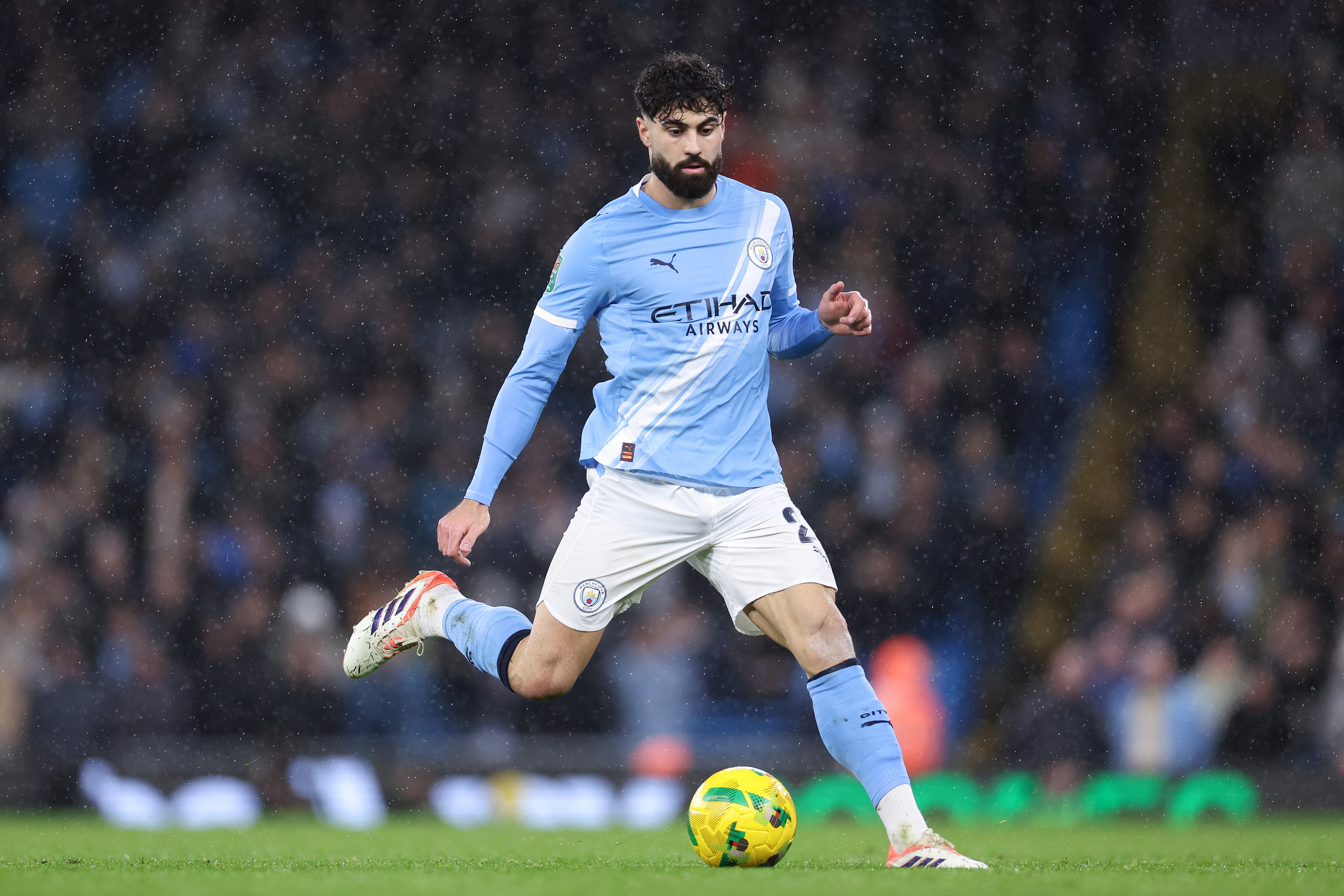 Manchester City defender Josko Gvardiol about to kick a football.