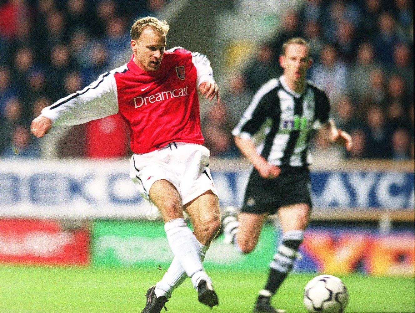 Dennis Bergkamp scores a goal for Arsenal during a Premier League match.