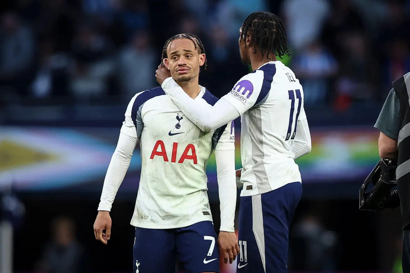 Mathys Tel consoling Xavi Simons during a football match.