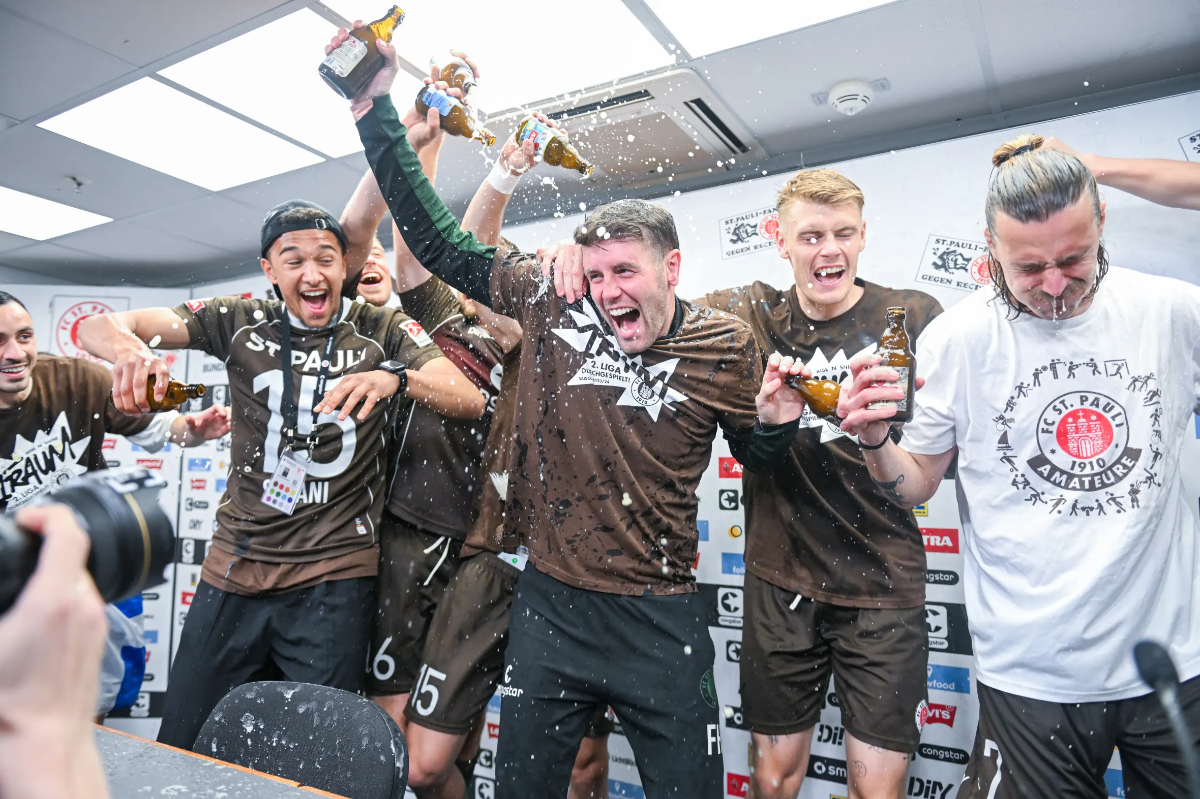 Soccer players celebrate with a beer shower.