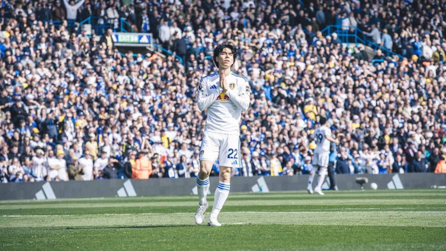 Ao Tanaka, moments before kick off, clasping his hands together and shutting his eyes as he basks in the sunshine of Elland Road