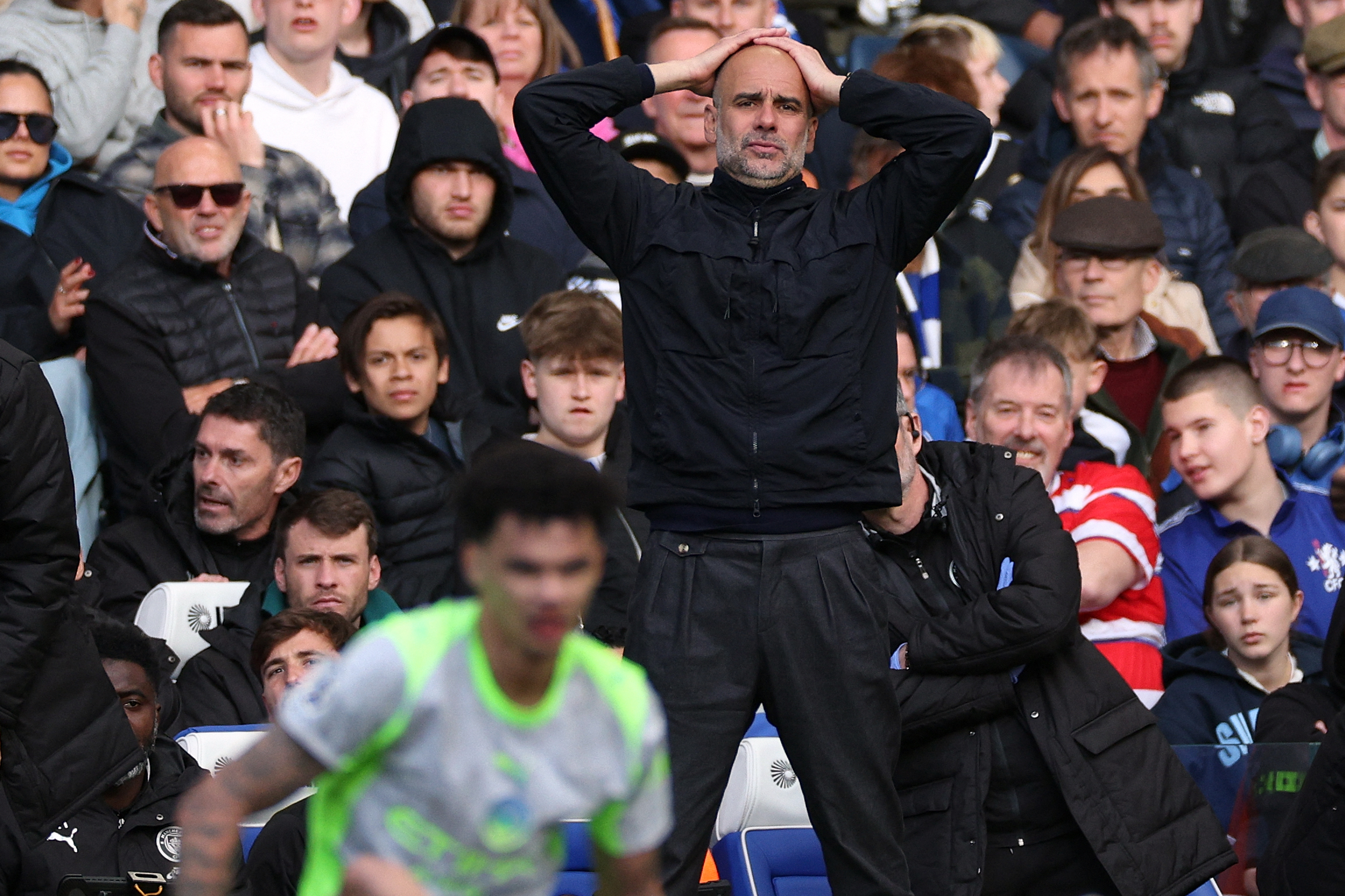 Manchester City's Spanish manager Pep Guardiola reacts and then substitutes Manchester City's English midfielder #33 Nico O'Reilly