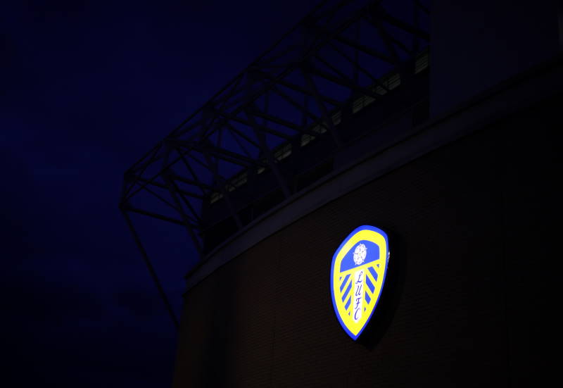 Leeds United's badge lit up on Elland Road at night