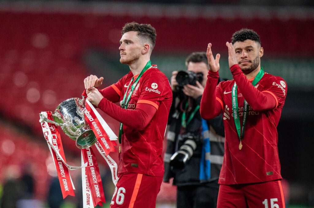 Andy Robertson and Alex Oxlade-Chamberlain applaud Liverpool fans with the League Cup trophy after beating Chelsea in the final at Wembley Stadium in 2022
