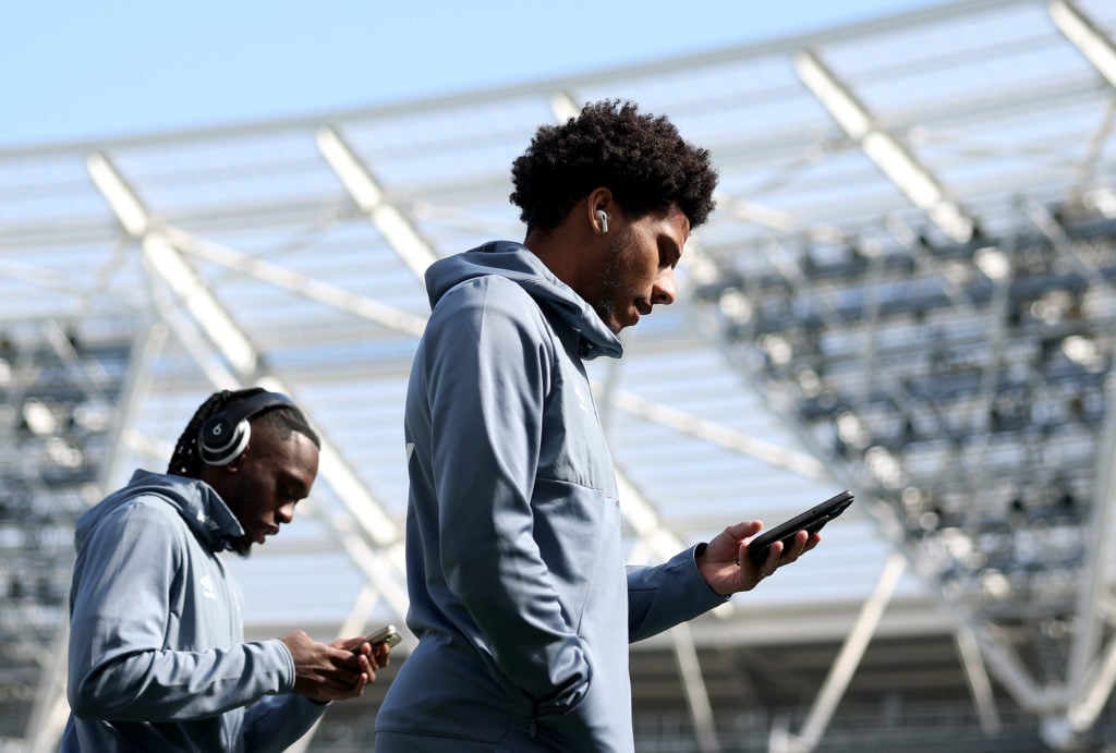 Jean-Clair Todibo looks at his phone on the London Stadium pitch before West Ham's Premier League clash with Bournemouth
