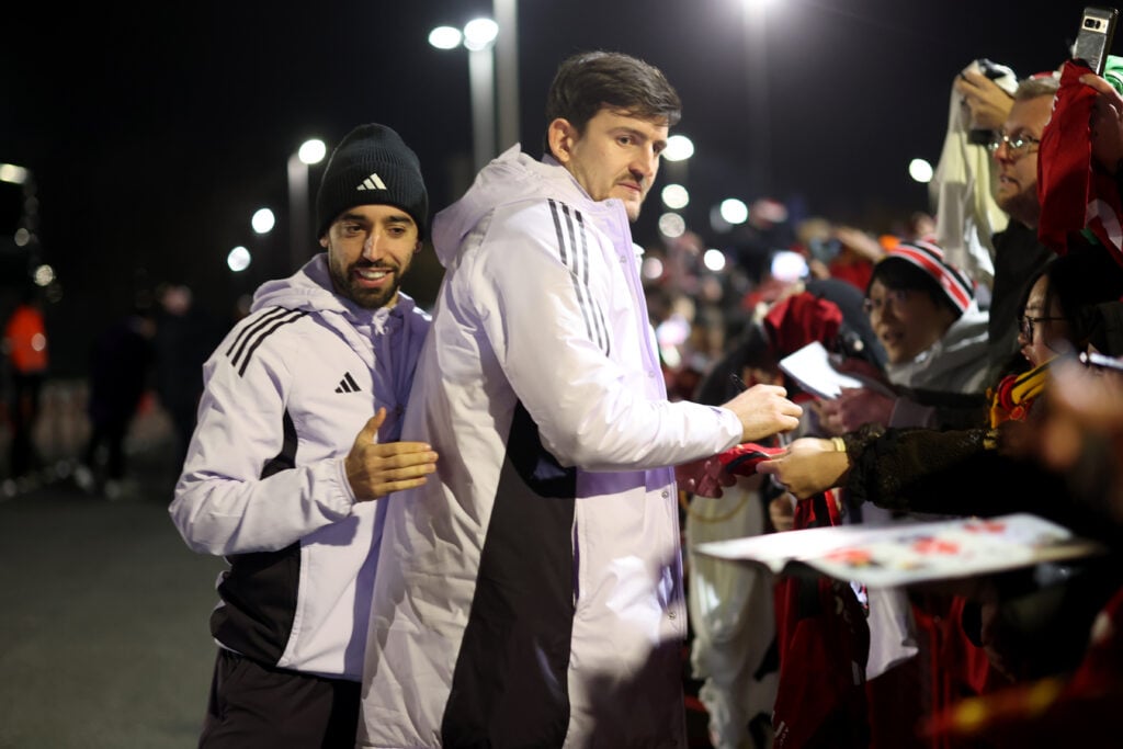 Bruno Fernandes and Harry Maguire signing autographs at Old Trafford