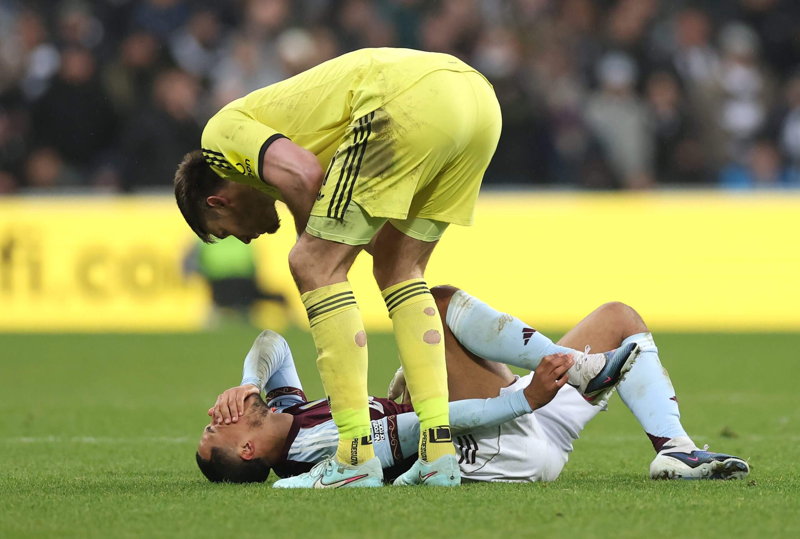 Youri Tielemans is consoled by Nick Pope after injuring his ankle at Newcastle
