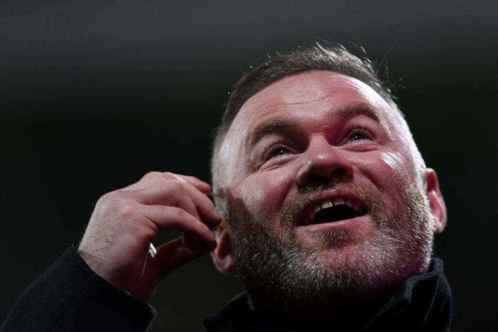 Former England and Manchester United player Wayne Rooney reacts at half-time during the FA Cup fifth-round football match between Wrexham and Chelsea at the Racecourse Ground Stadium in Wrexham, Wales, in 2026.