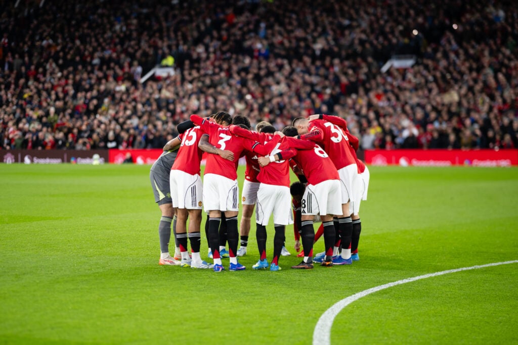 Manchester United team huddle at Old Trafford.
