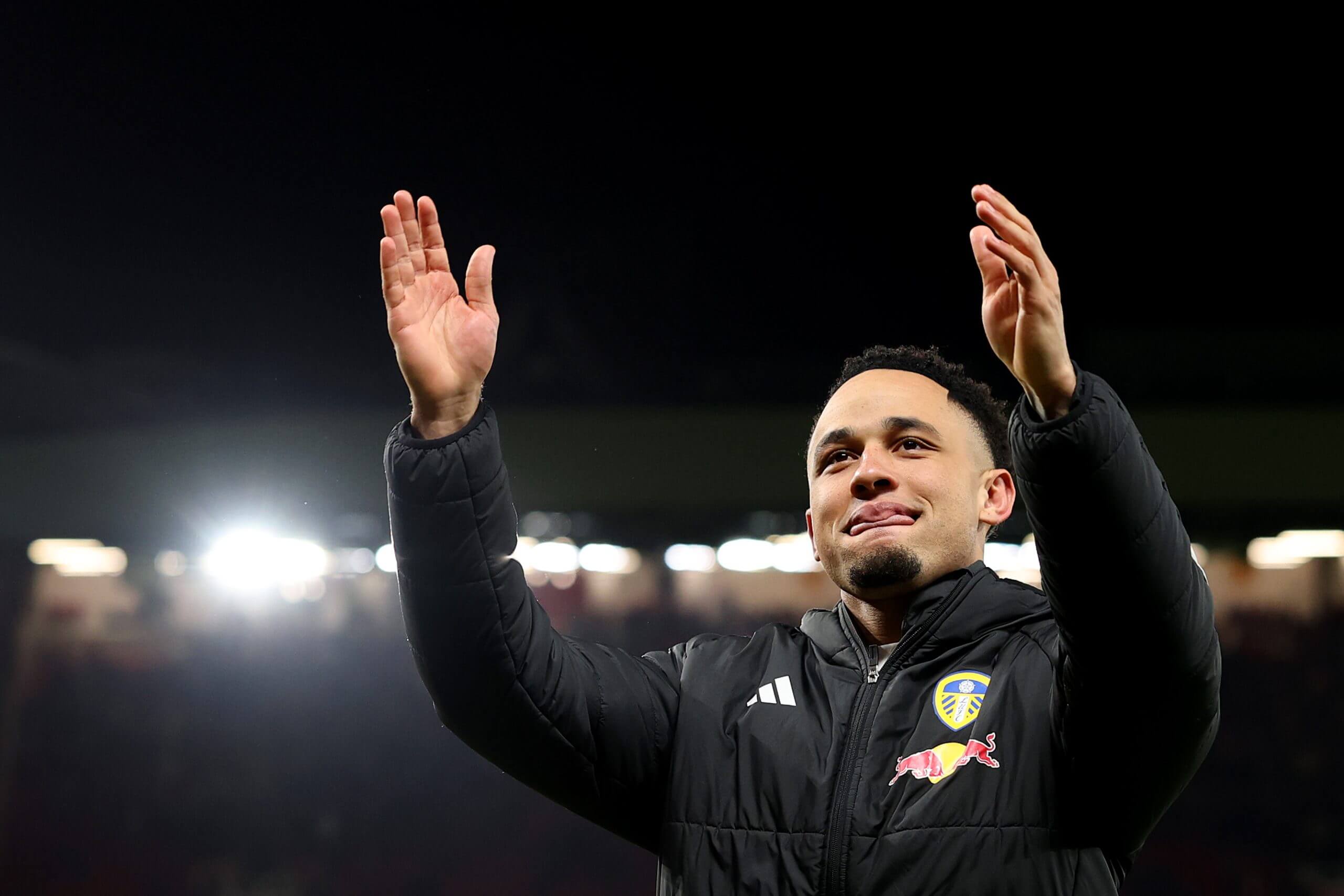 Noah Okafor approaches the away fans at Old Trafford after Leeds United's win over Manchester United