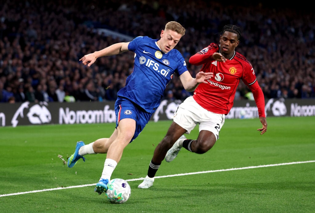 Liam Delap of Chelsea runs with the ball while under pressure from Ayden Heaven of Manchester United during the Premier League match between Chelsea and Manchester United at Stamford Bridge on April 18, 2026
