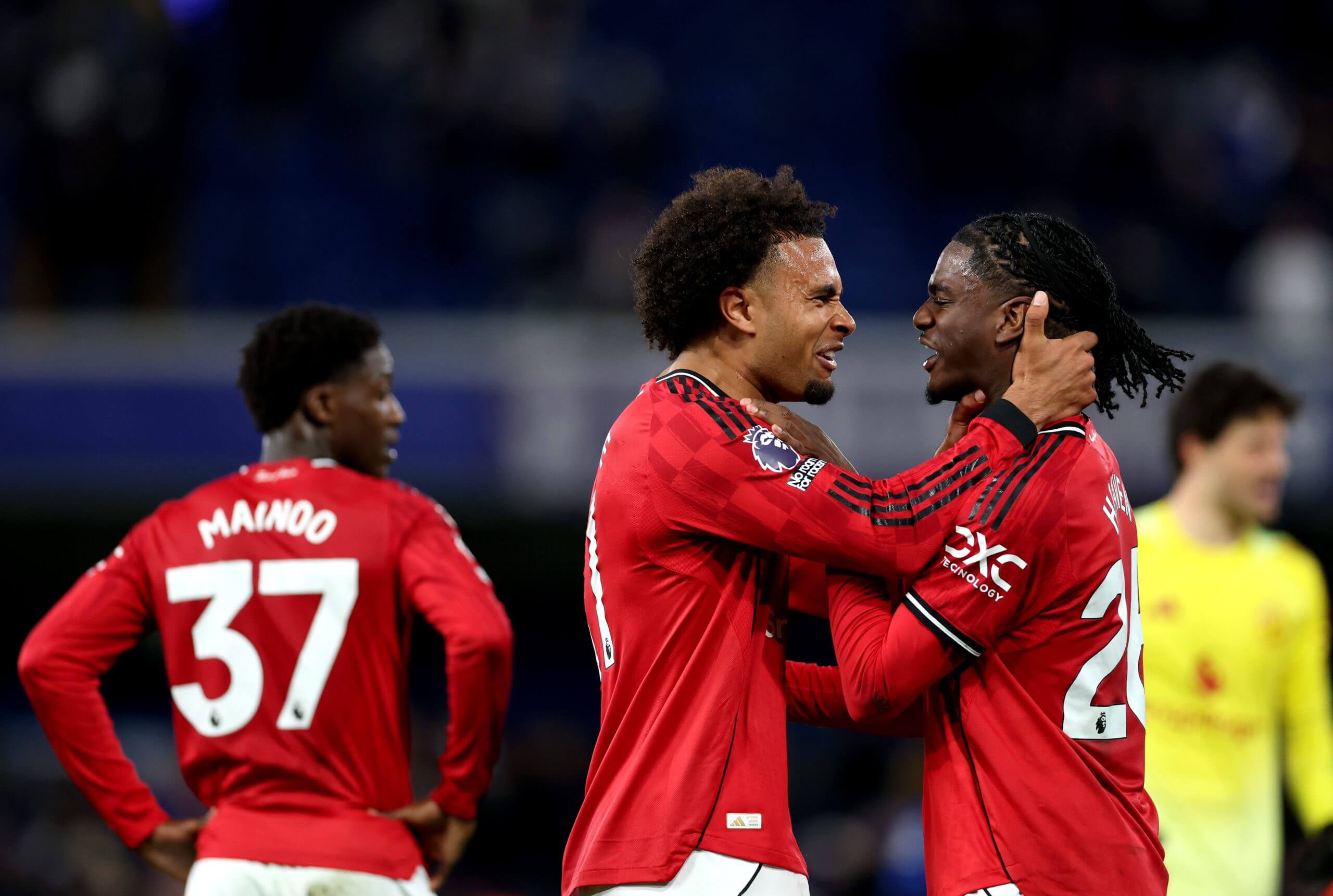 Joshua Zirkzee grasps the neck of team-mate Ayden Heaven as they celebrate Manchester United's win over Chelsea