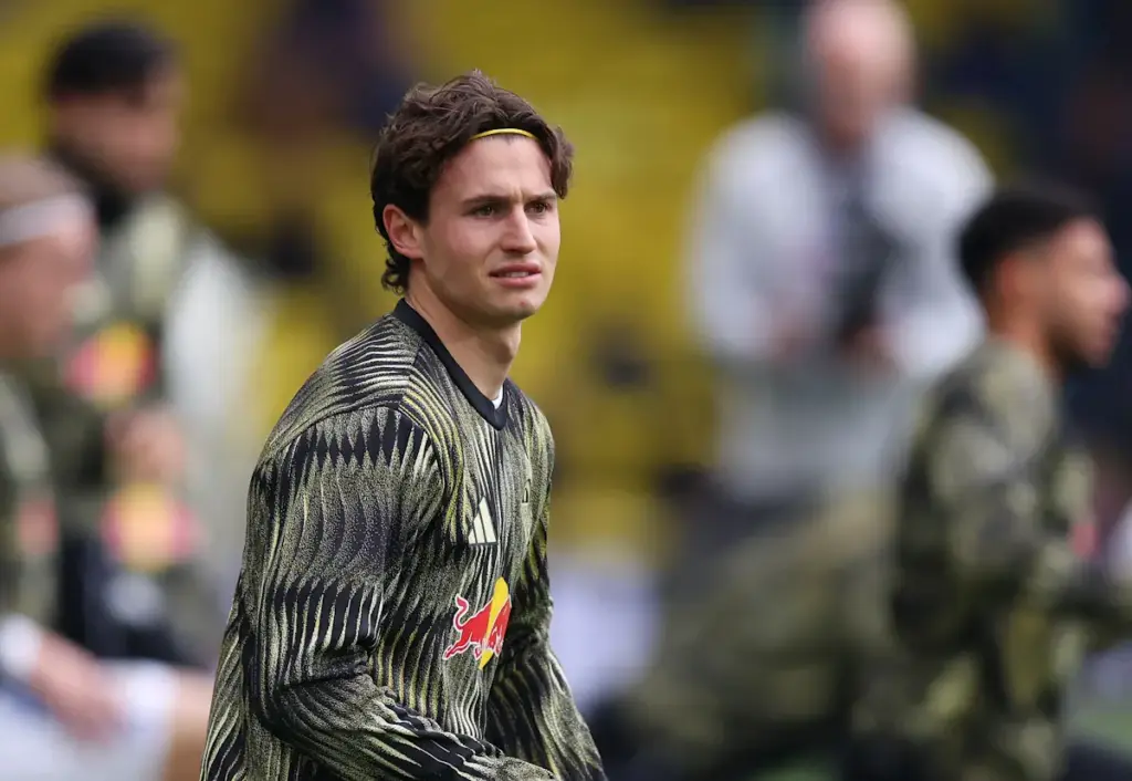 Brenden Aaronson stretches and warms up for Leeds United before a match