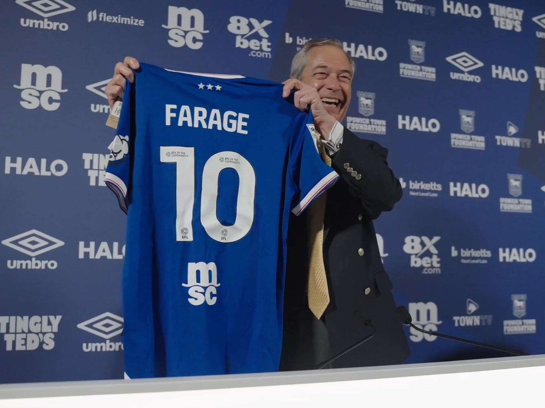 The Reform UK leader standing with a number 10 Farage shirt. Picture: LDRS/Reform