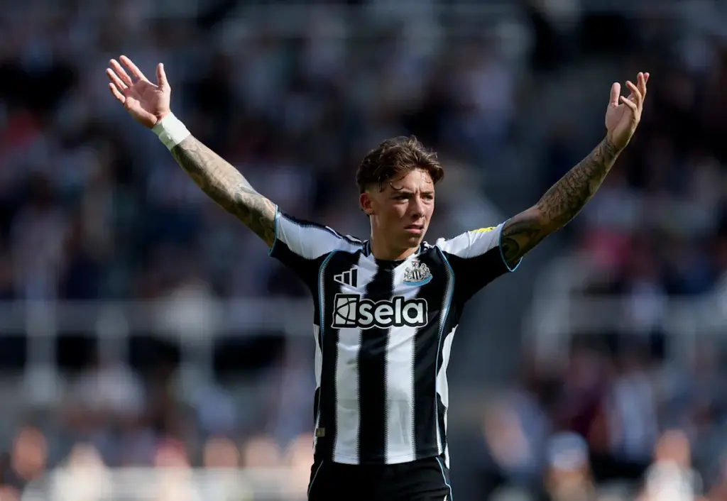 Harrison Ashby raises his arms to signal his team-mates when playing for Newcastle United