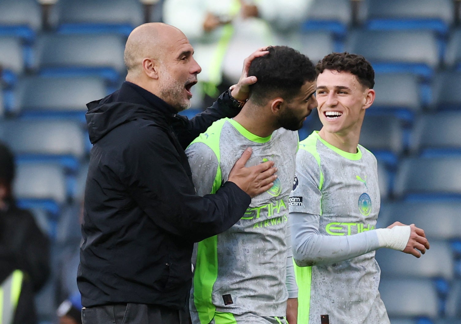 Pep Guardiola celebrates with his players at full-time