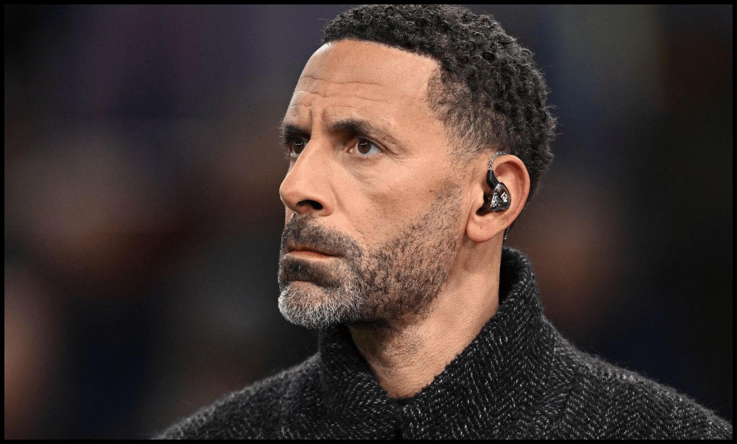 Rio Ferdinand looks on while on punditry at Villa Park.