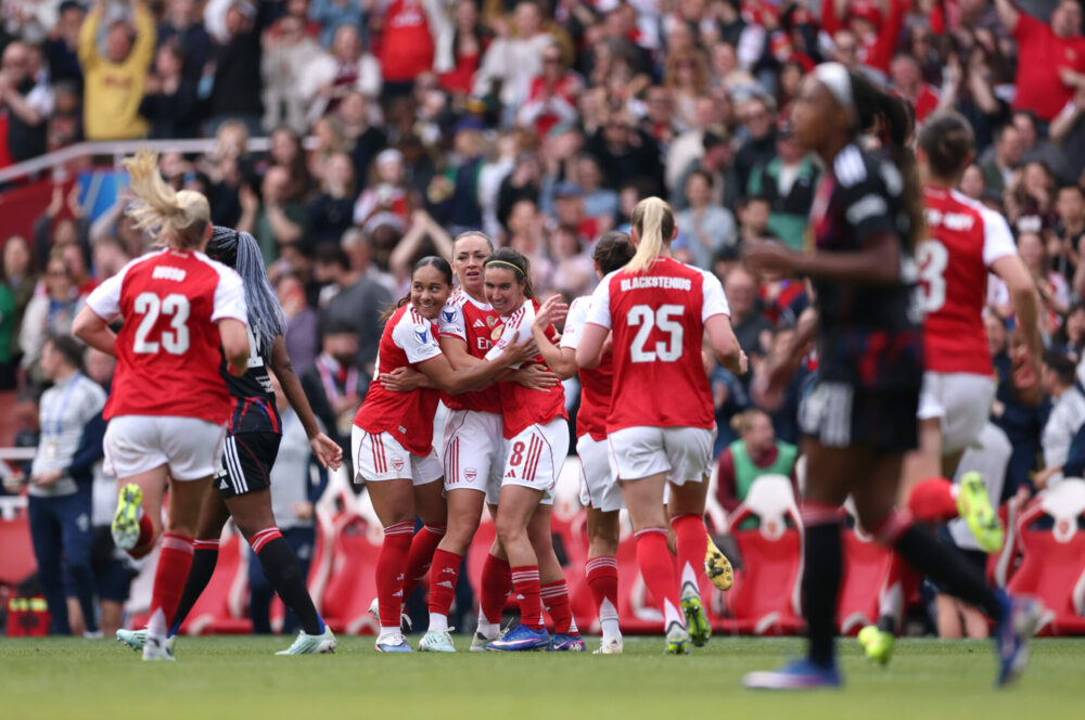 Arsenal women celebrate scoring an equaliser against Lyon