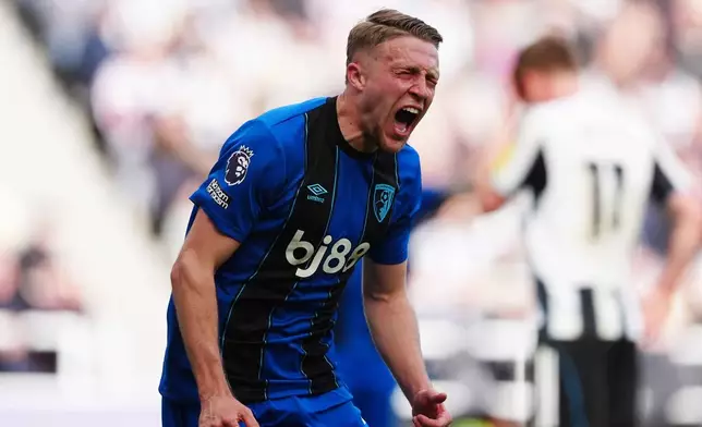 Bournemouth's Adrien Truffert celebrates scoring their side's second goal of the game during the English Premier League soccer match between Newcastle United and AFC Bournemouth, Saturday, April 18, 2026, in Newcastle, England. (Owen Humphreys/PA via AP)