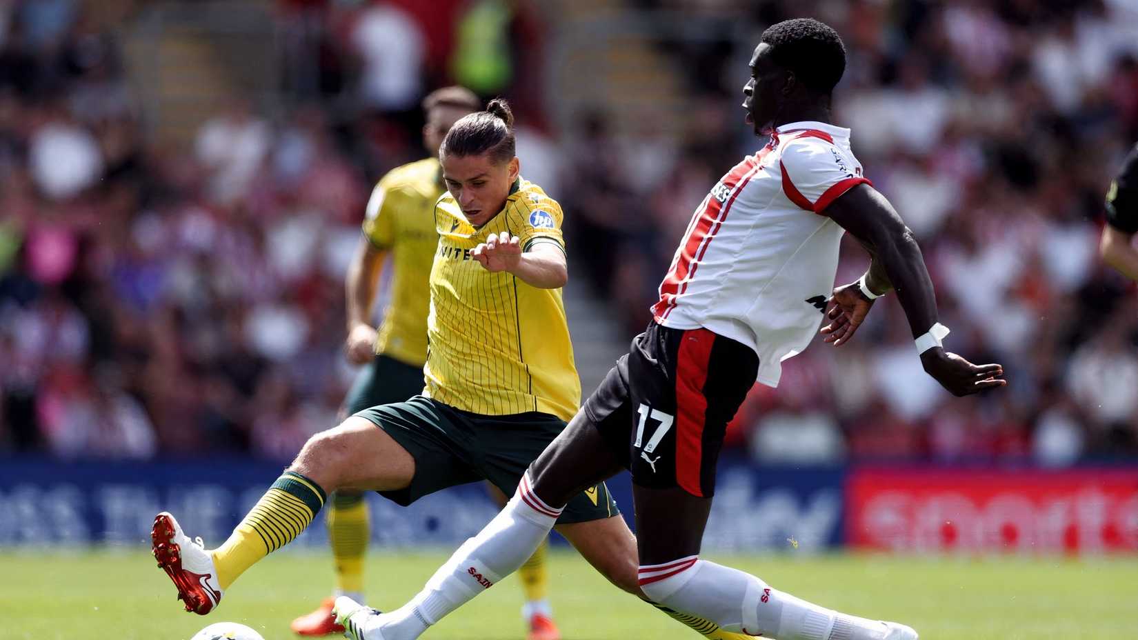 Wrexham's George Dobson in action with Southampton's Joshua Quarshie